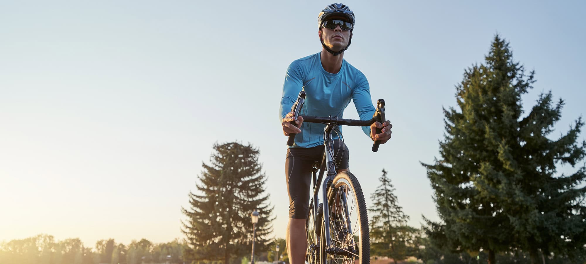 man riding bike down a street