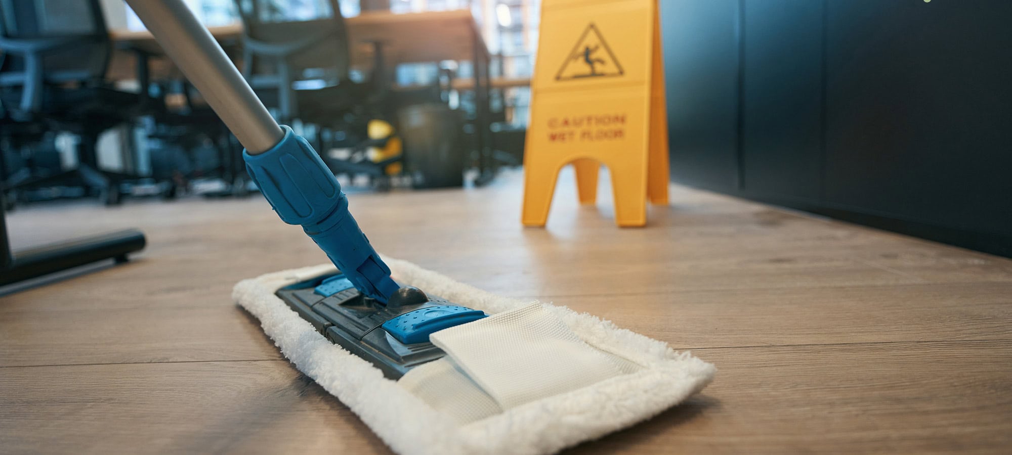 Mopping hardwood floors in a business