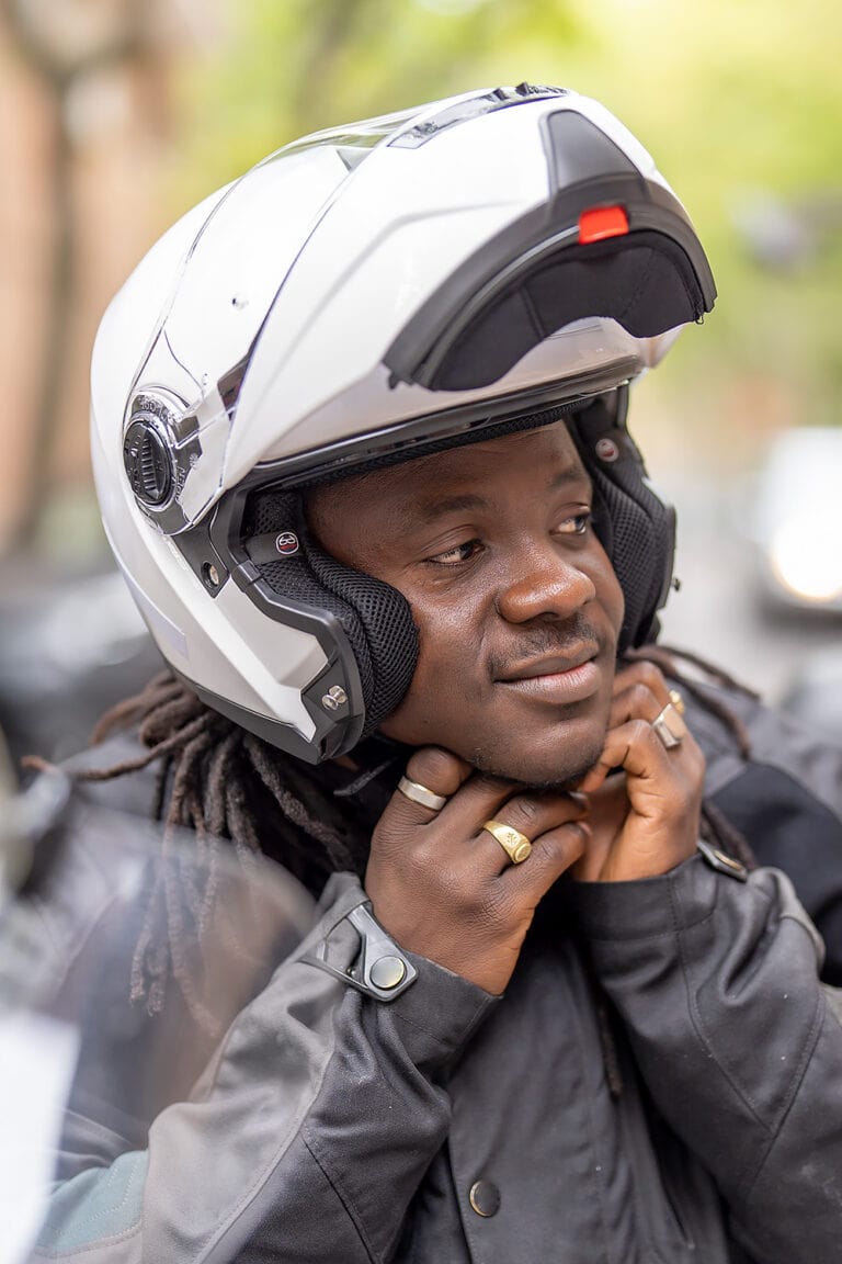 Man strapping on his motorcycle helmet