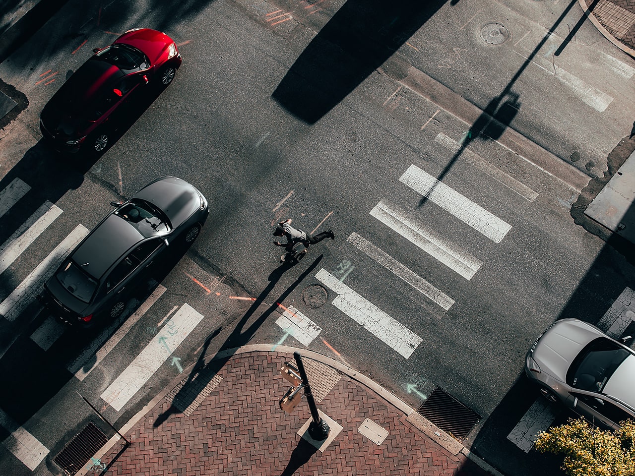 Skate boarder going through crosswalk