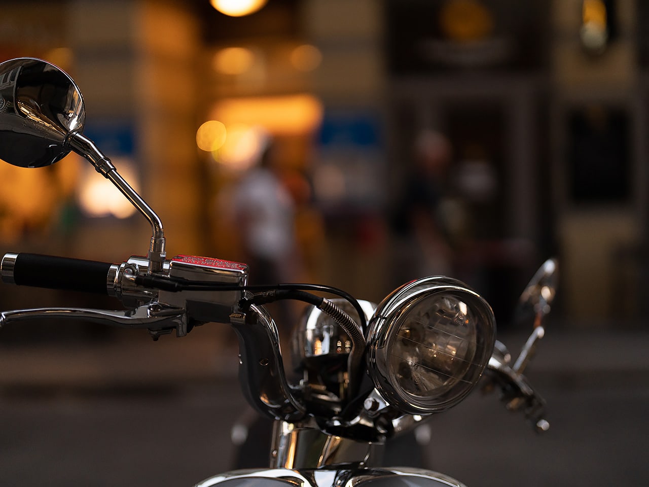 Vintage motorcycle handlebars at night